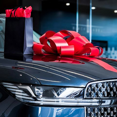 Photo: A gift bow on the hood of a new car. Photo by Obi.